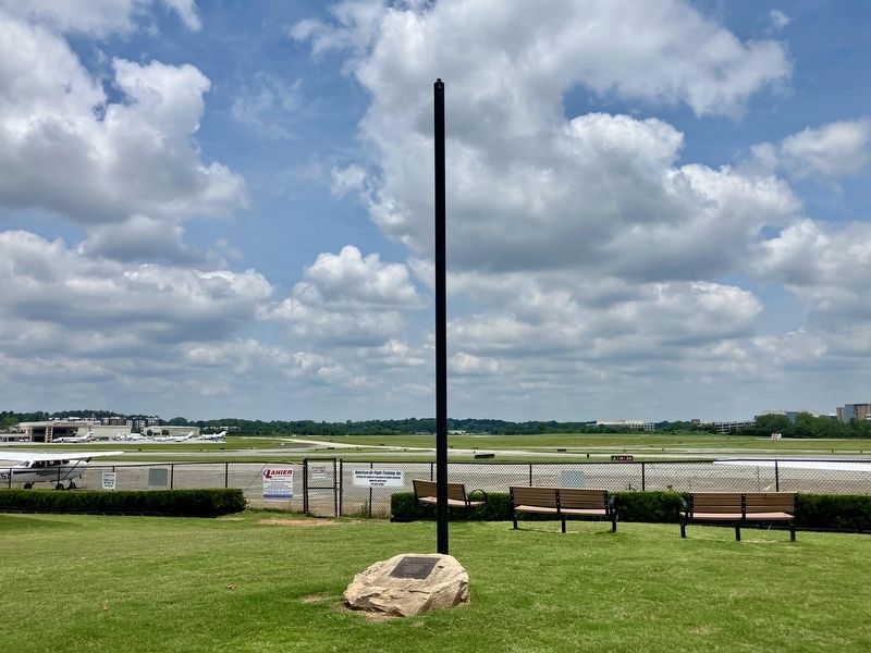 marker shown as mounted on stone with pole and with Peachtree-DeKalb Airport runways in background. Click for full size. marker shown as mounted on stone with pole and with Peachtree-DeKalb Airport runways in background image. Click for full size.
