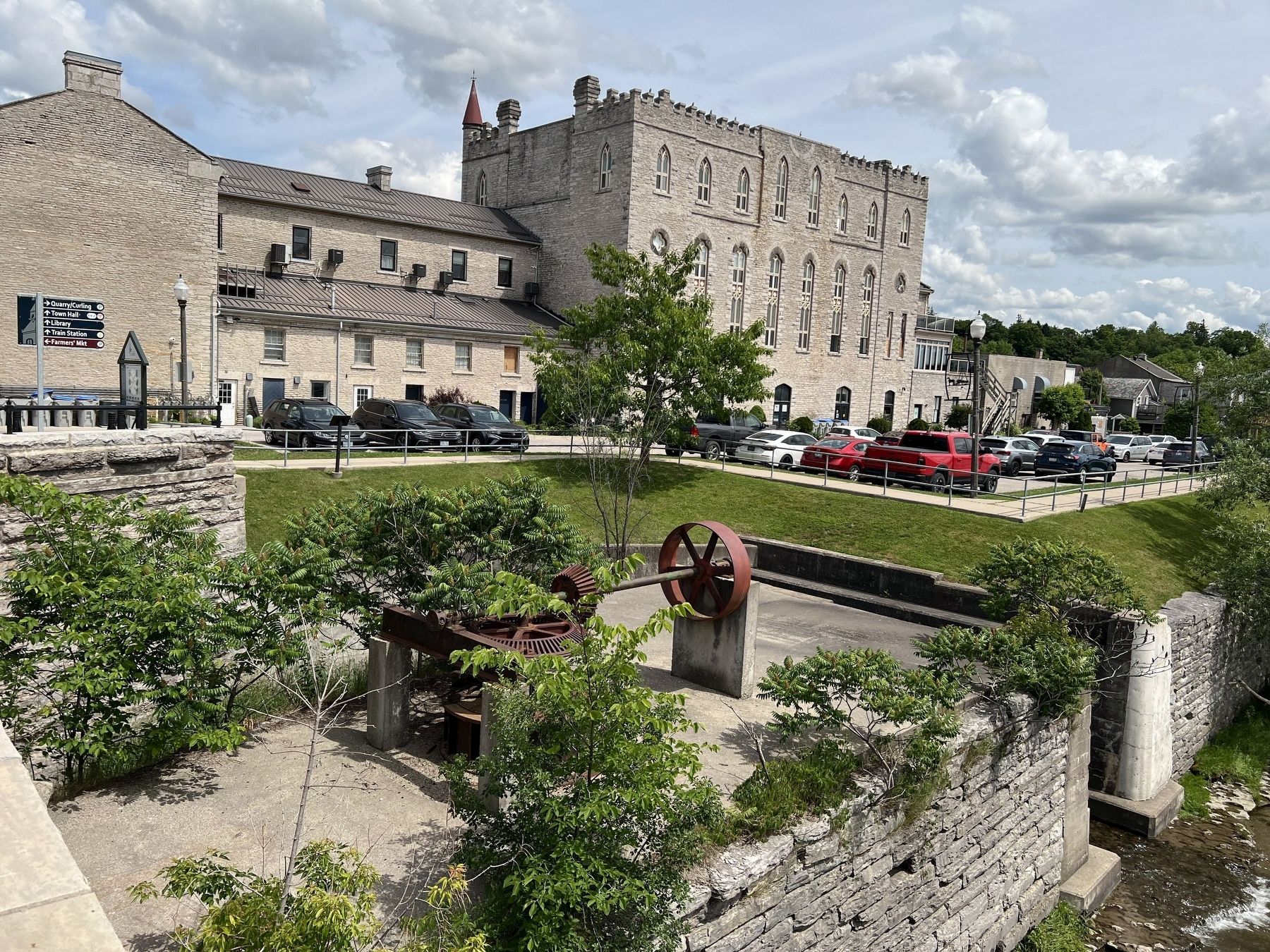 Restored mill wheel (the back of the marker is visible by the leftmost parked car). Click for full size. Restored mill wheel (the back of the marker is visible by the leftmost parked car) image. Click for full size.
