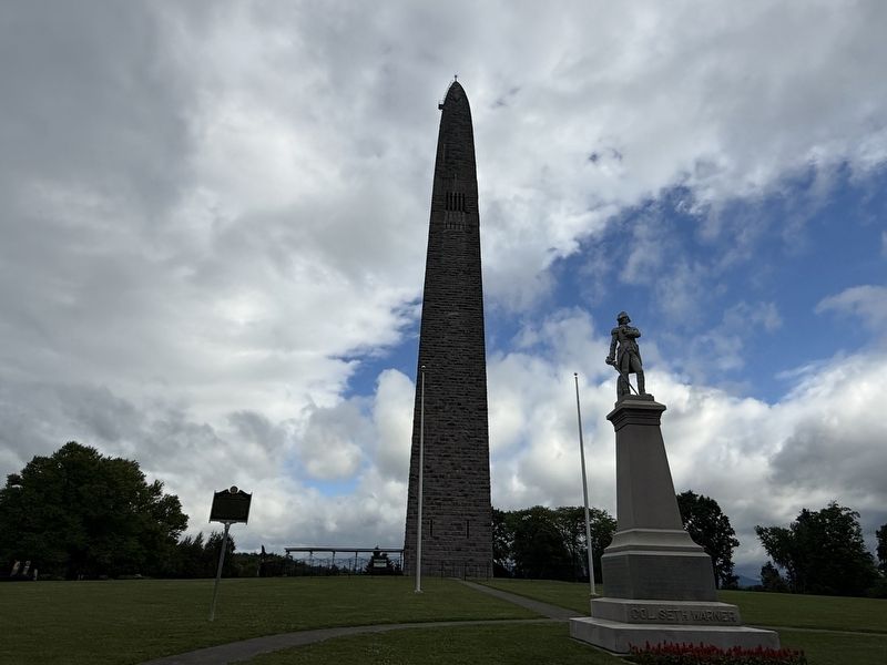 Seth Warner Marker near a statue of his likeness on the grounds of the Bennington Battle Monument image. Click for full size.
