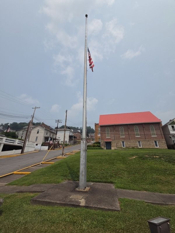Time Capsule Marker and Flagpole. Horizons Church is in the background. image. Click for full size.