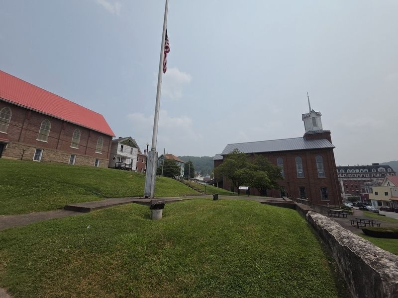 Time Capsule Marker and Flagpole. Mother's Day Shrine Church is in the background on the right image. Click for full size.