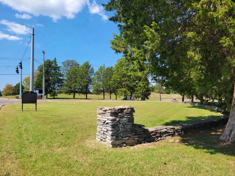 Marker with stone structures marking the original entrance to the Training Center image. Click for full size.