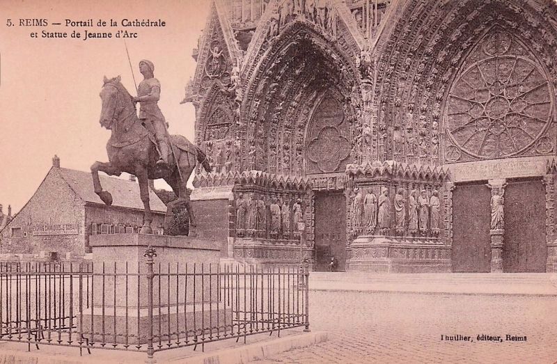 Cathedral doors and Statue of Joan of Arc. Click for full size. Cathedral doors and Statue of Joan of Arc image. Click for full size.