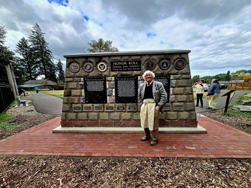 Distance view of the marker with stone carver Keith Phillips. image. Click for full size.